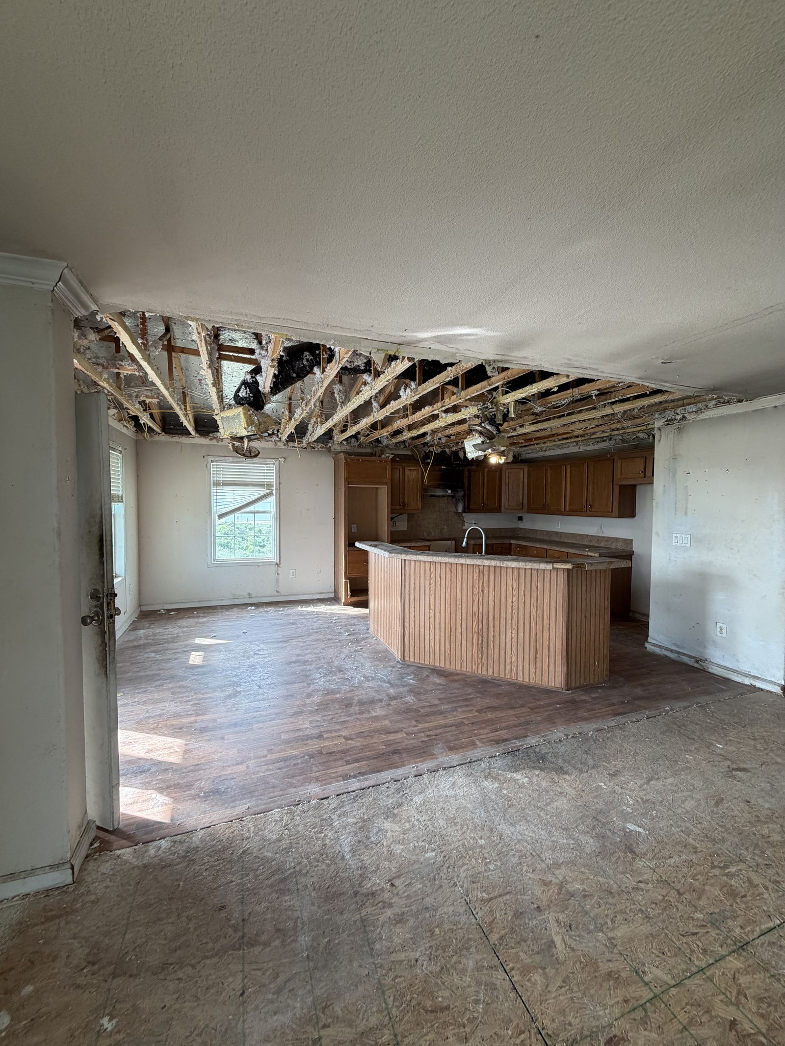 Storm-damaged interior of a home purchased as-is